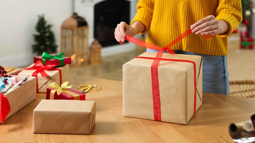 Gold Buyers Make Extra Christmas Cash Girl In Yellow Jumper Wrapping Present