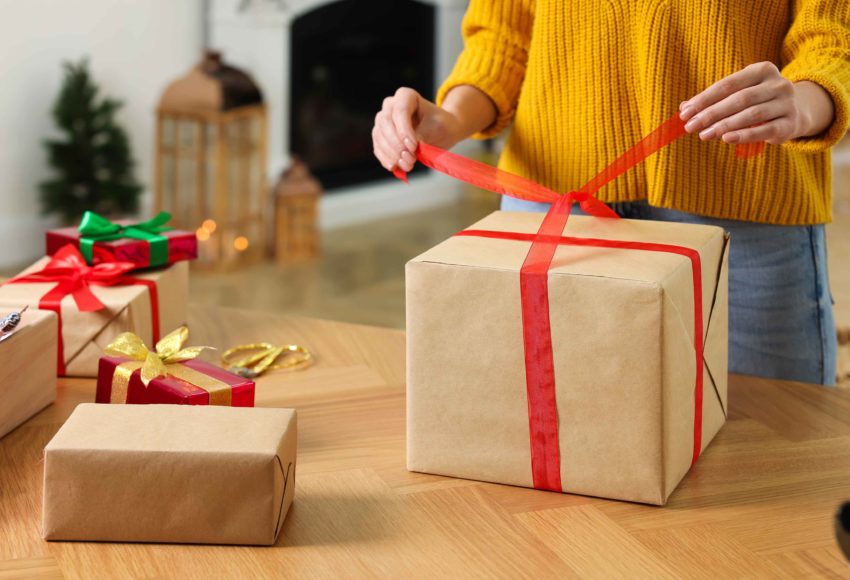 Gold Buyers Make Extra Christmas Girl In Yellow Jumper Wrapping Present